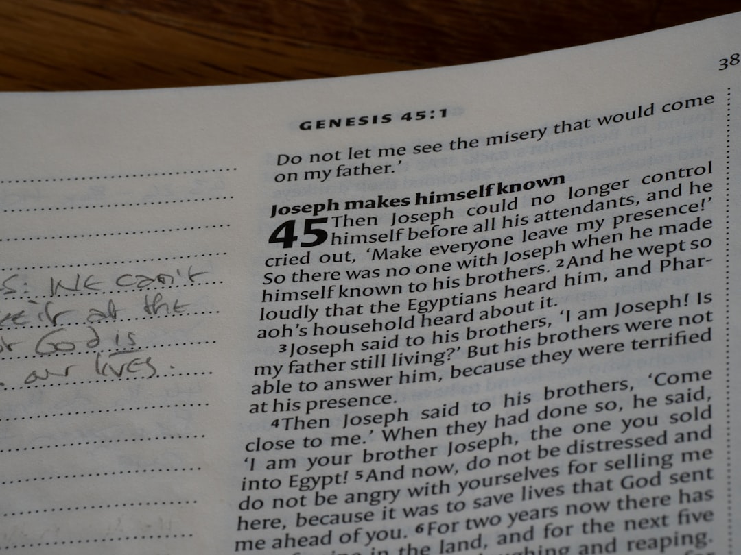 Open bible page with handwritten notes on the side.
