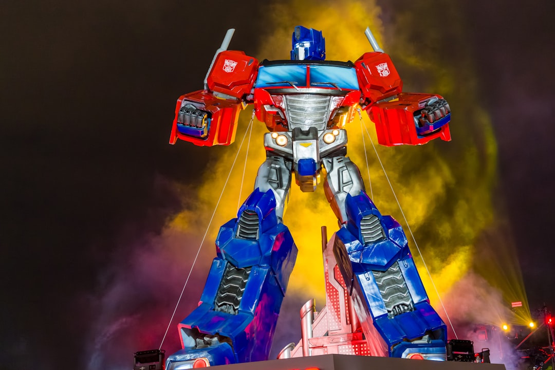 Giant optimus prime statue illuminated at night
