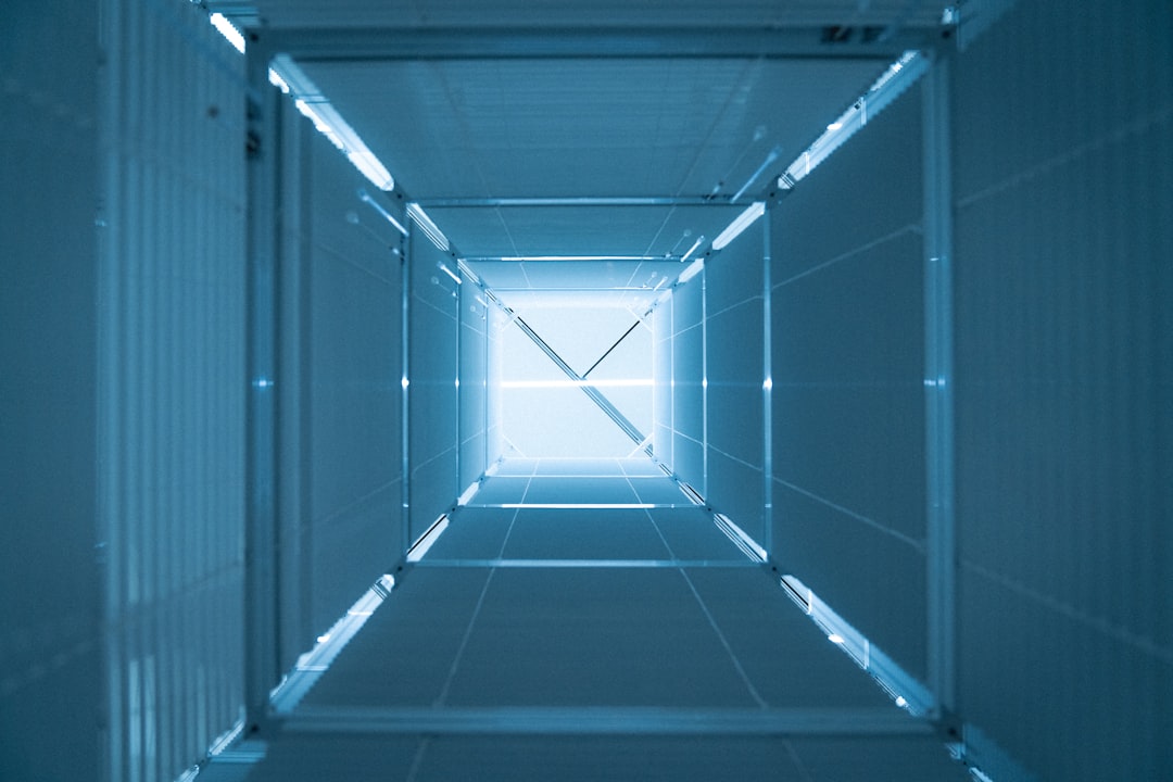 A very long narrow room with a light at the end