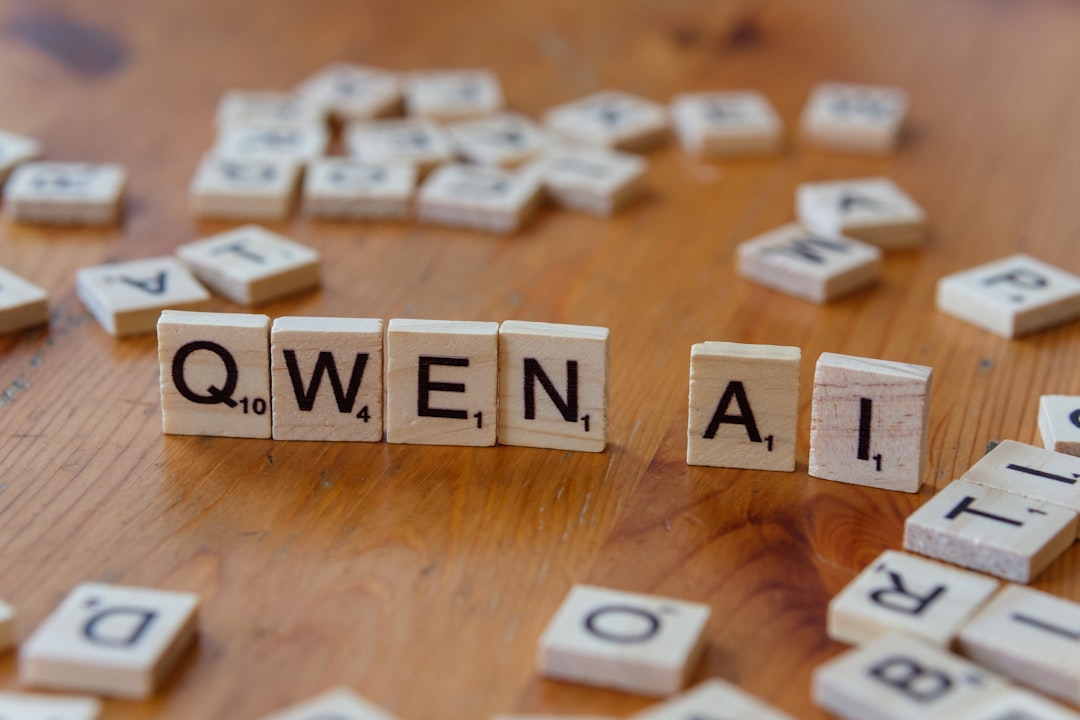 A wooden table topped with scrabble tiles spelling queen ali