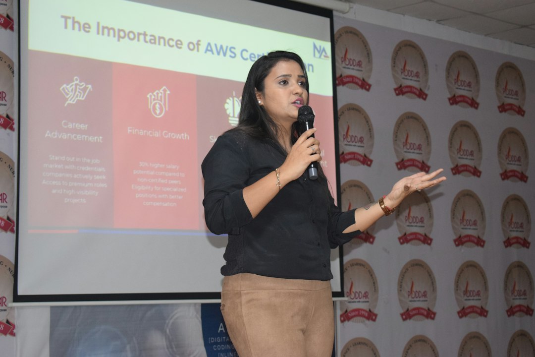 Female speaker presenting in front of a projector screen