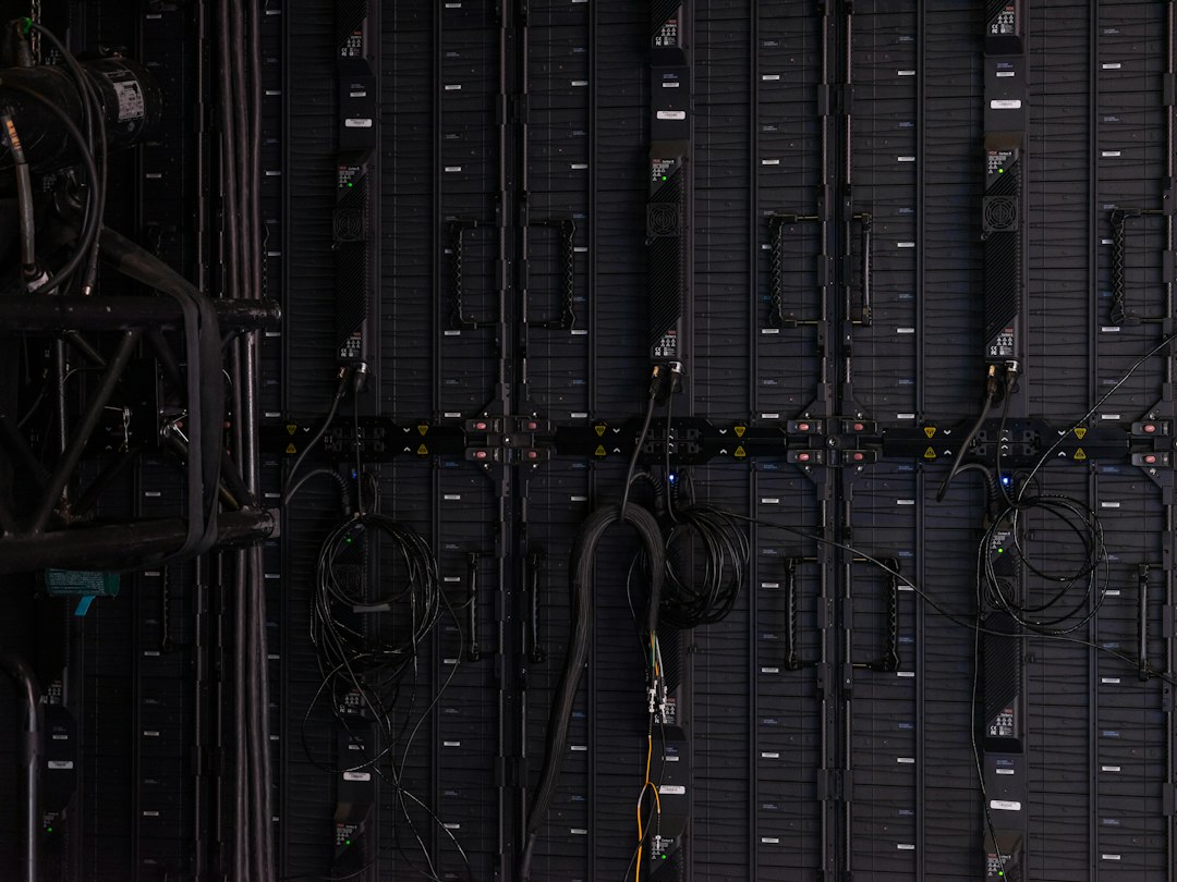 Black cables and wires connected to the back of modular LED display panels