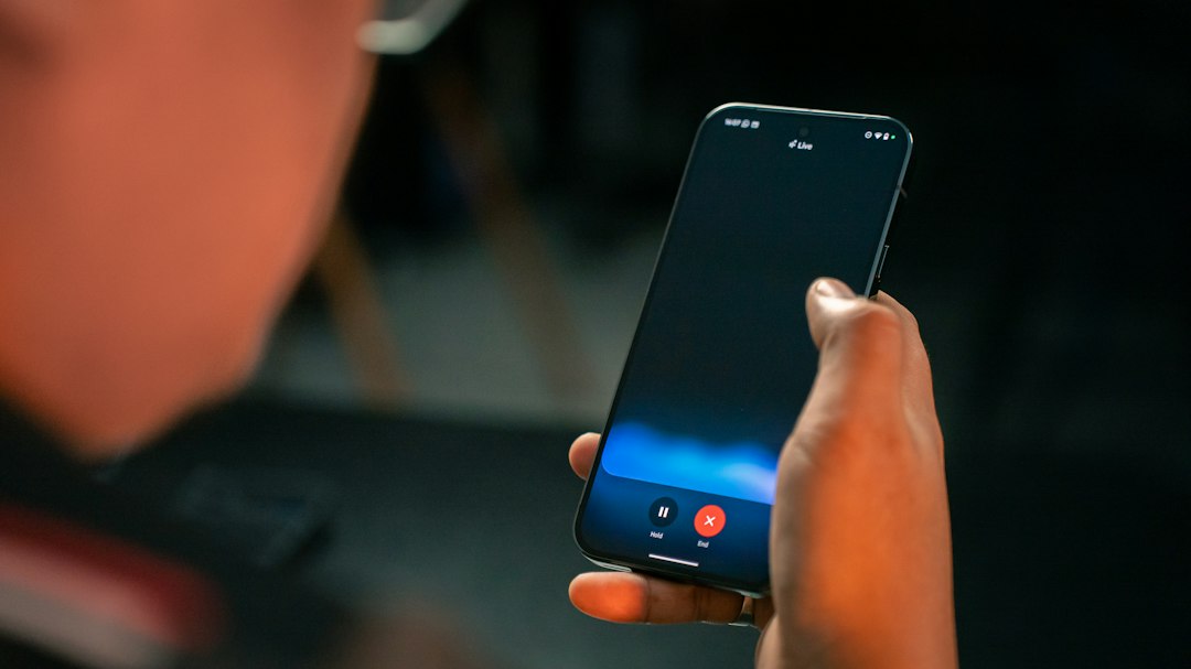 A person holding a cell phone in their hand