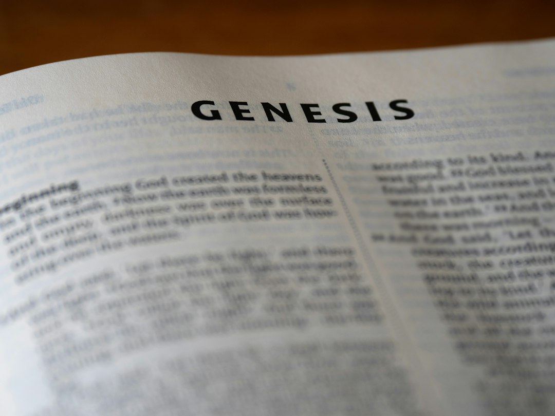 The image shows an open bible book of genesis